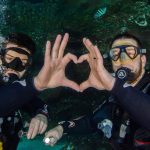 Divers making a heart with their hands
